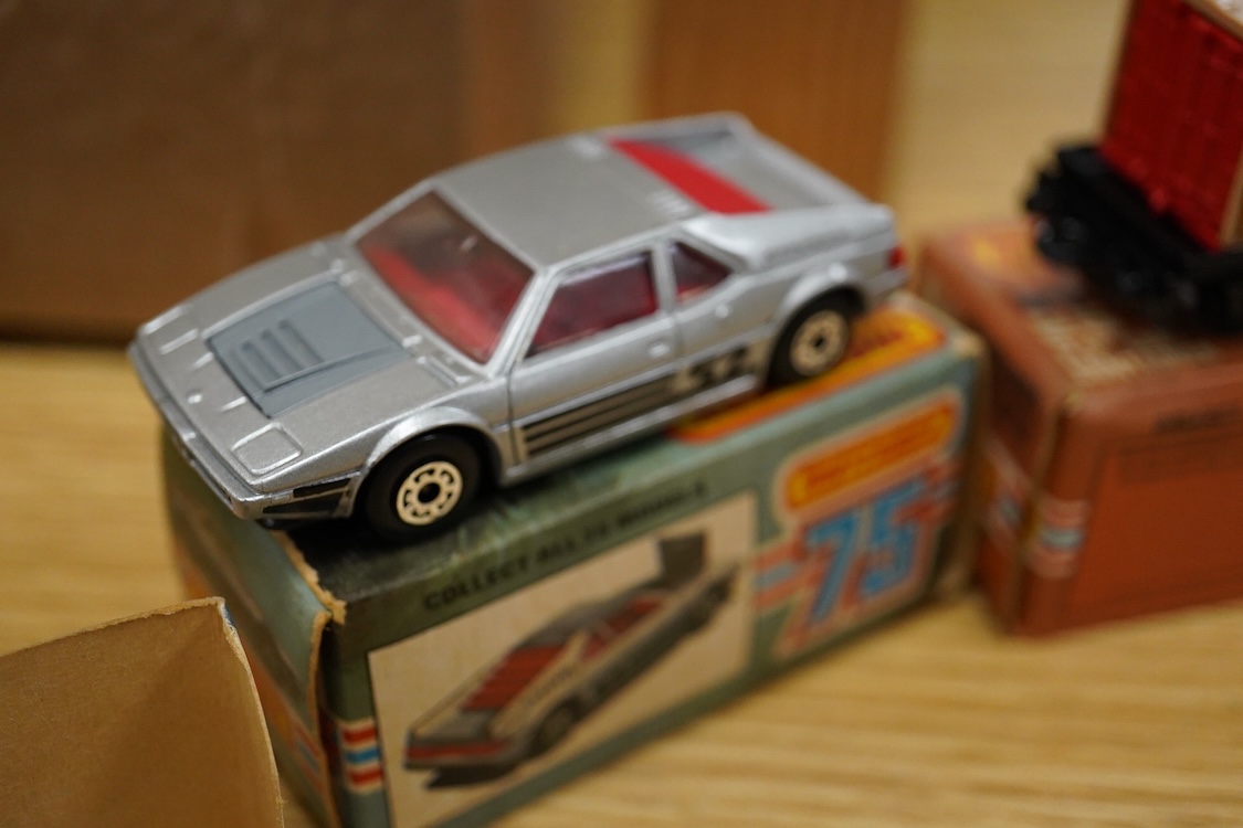 Twelve boxed Matchbox Superfast and Rola-matics 1-75 vehicles; VW Golf (7), petrol tanker (14), Badger (16), Blaze Buster (22), Atlas truck (23), diesel shunter (24), flat car with container (25), passenger coach (44), K